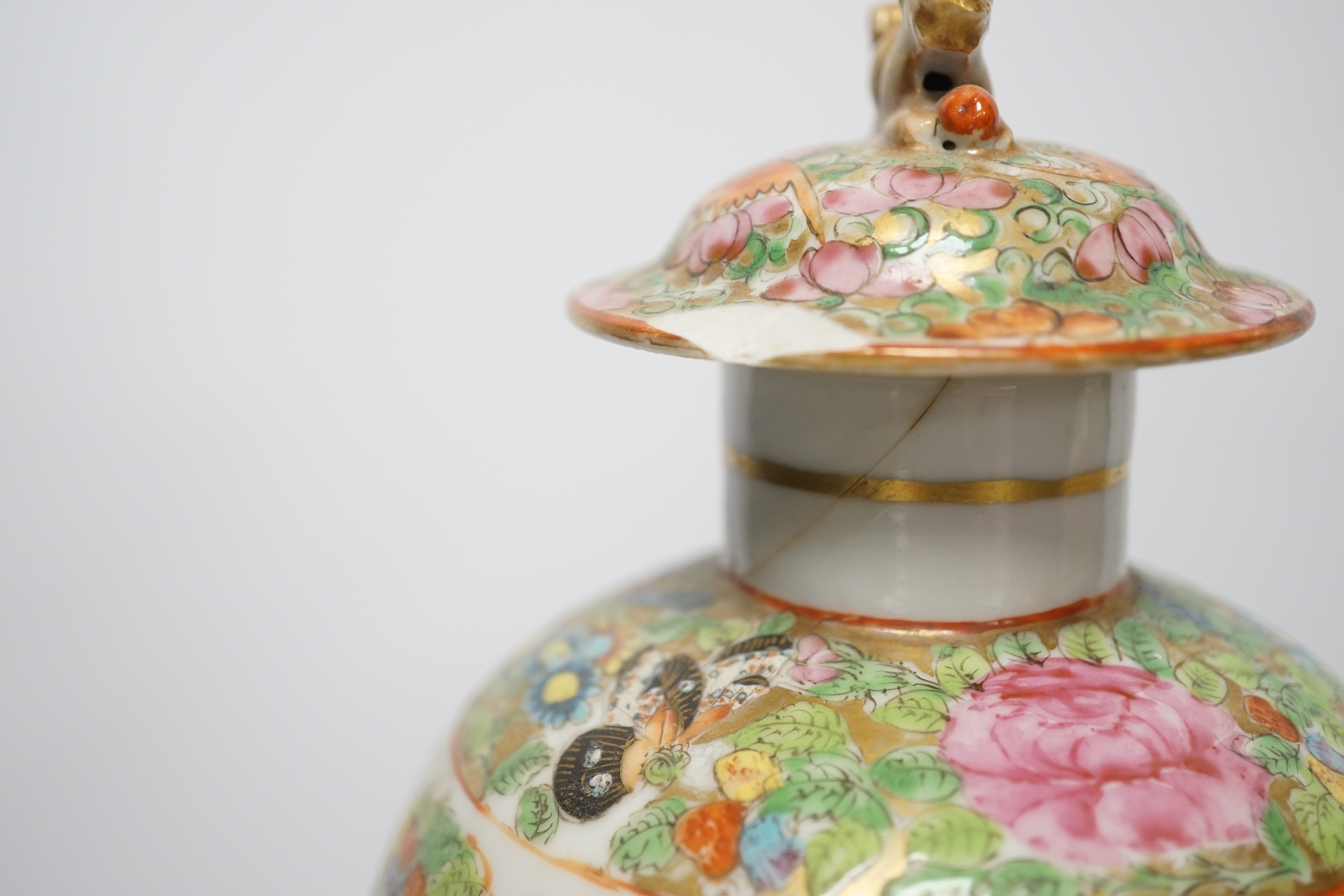 A pair of 19th century Chinese famille rose vases and covers, a similar small vase and a a famille verte crackle glaze jar, tallest 31cm